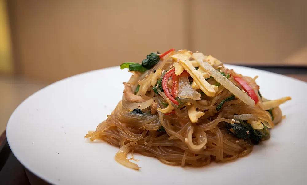 Japchae glass noodles tossed with colorful vegetables