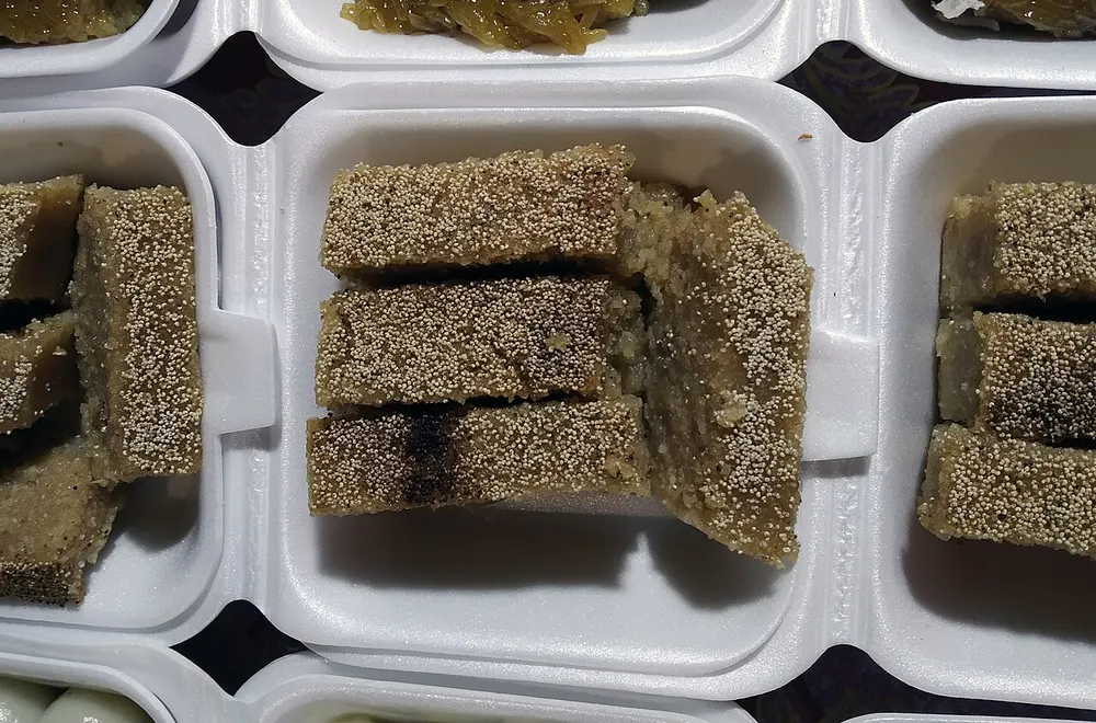 Slices of sanwin makin — dense semolina cake with a poppy-seed crust