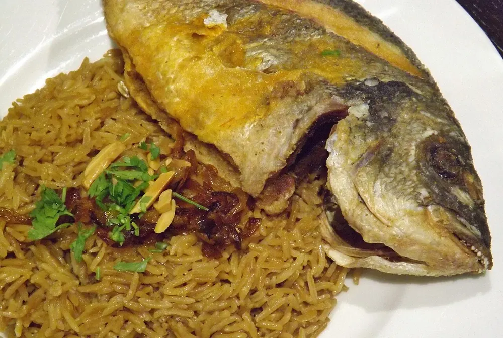 Sayadieh — fried fish on onion-browned rice with almonds and parsley