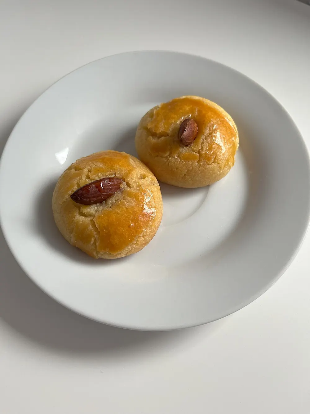 Şekerpare — soft semolina cookies in syrup, each topped with an almond