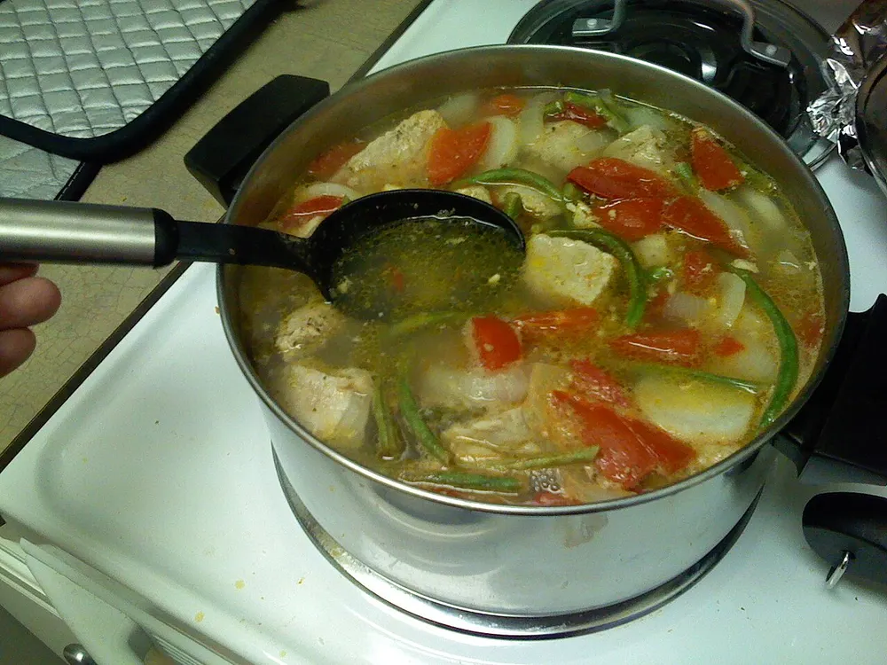 Sinigang na baboy — sour tamarind pork soup with vegetables