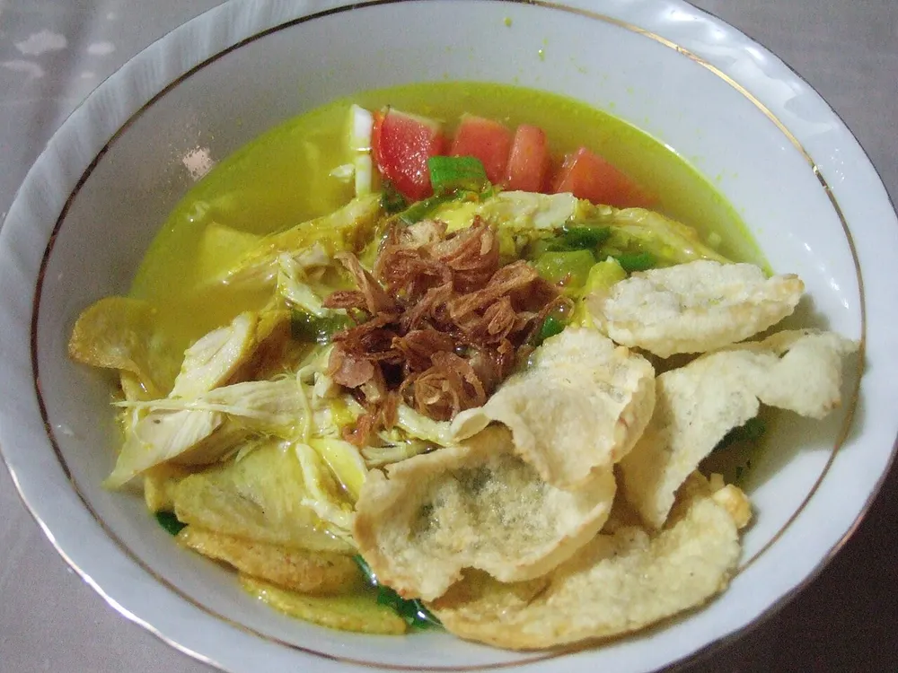 Soto ayam — turmeric chicken soup with shredded chicken and fried shallots