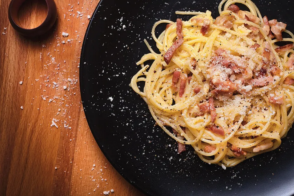 Spaghetti in a glossy egg sauce with cubes of crisp guanciale, grated pecorino and black pepper