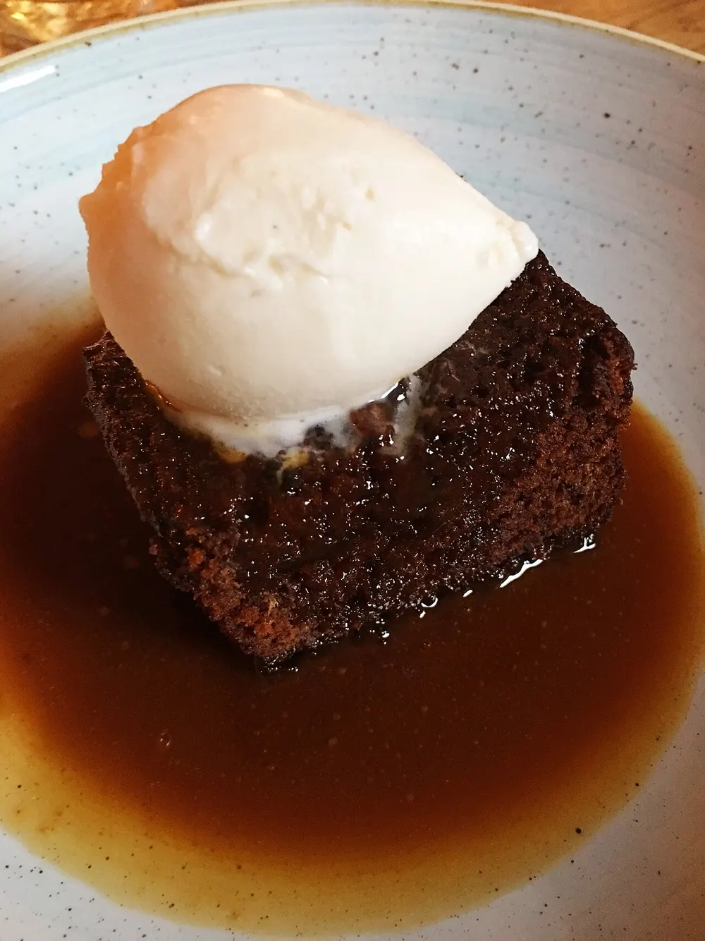 Sticky toffee pudding — date sponge in toffee sauce with ice cream