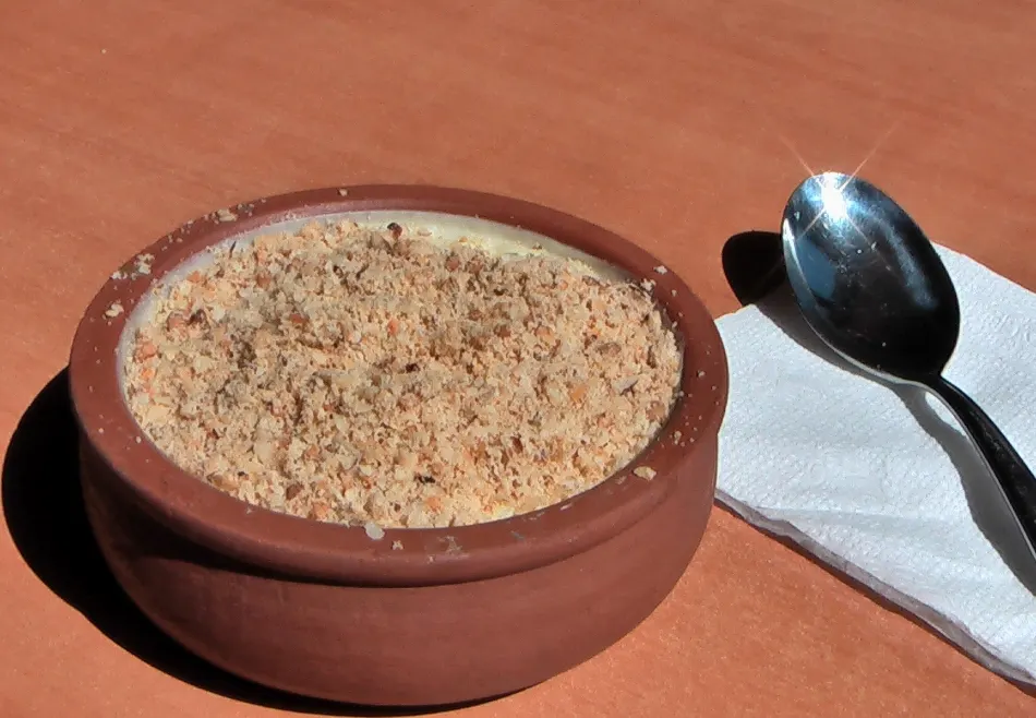 Rice pudding in a clay bowl with a browned nutty top