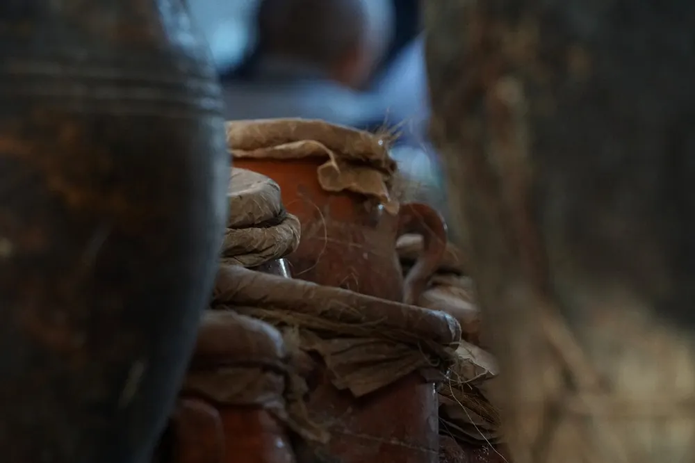 Tanjia โ clay urns sealed for slow cooking, stacked at a Marrakech shop