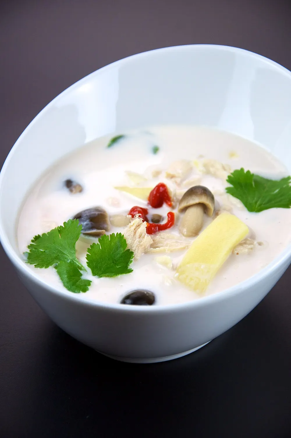 Tom kha gai — chicken in coconut milk soup with galangal and mushrooms