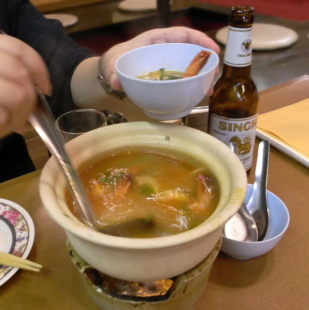 Tom yum goong — hot-and-sour Thai shrimp soup in a clay pot