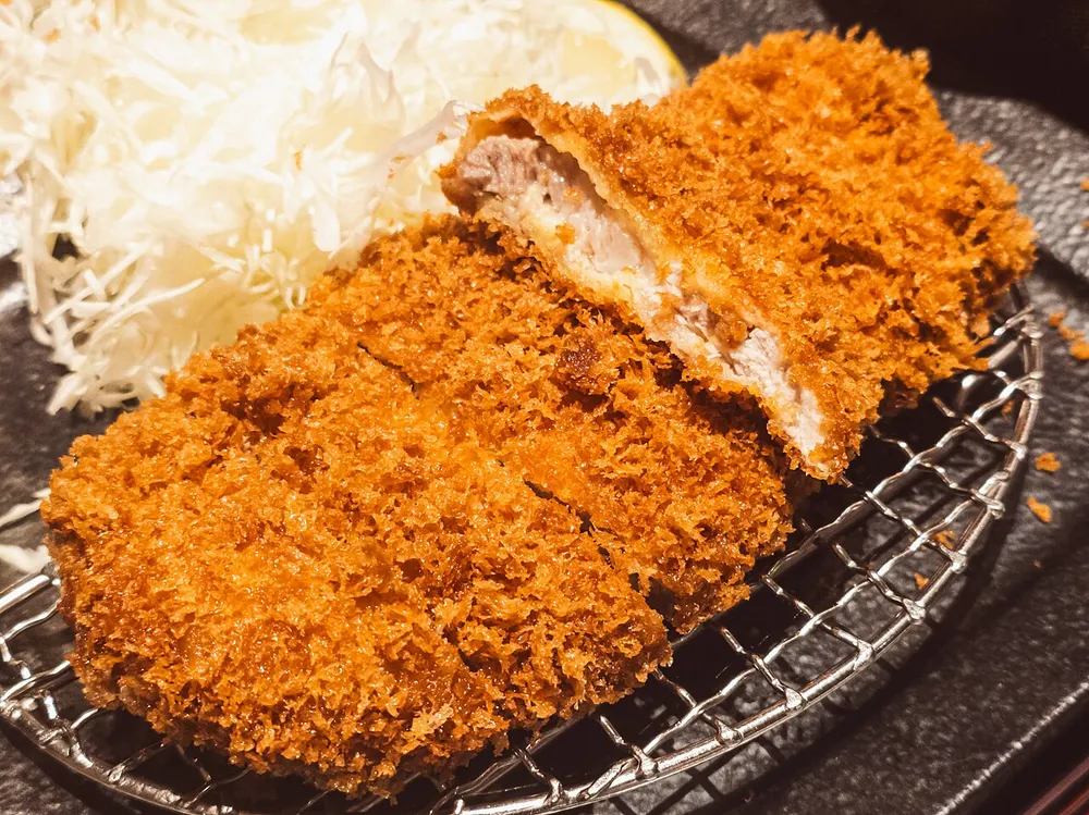 A sliced tonkatsu pork cutlet with crisp panko crust