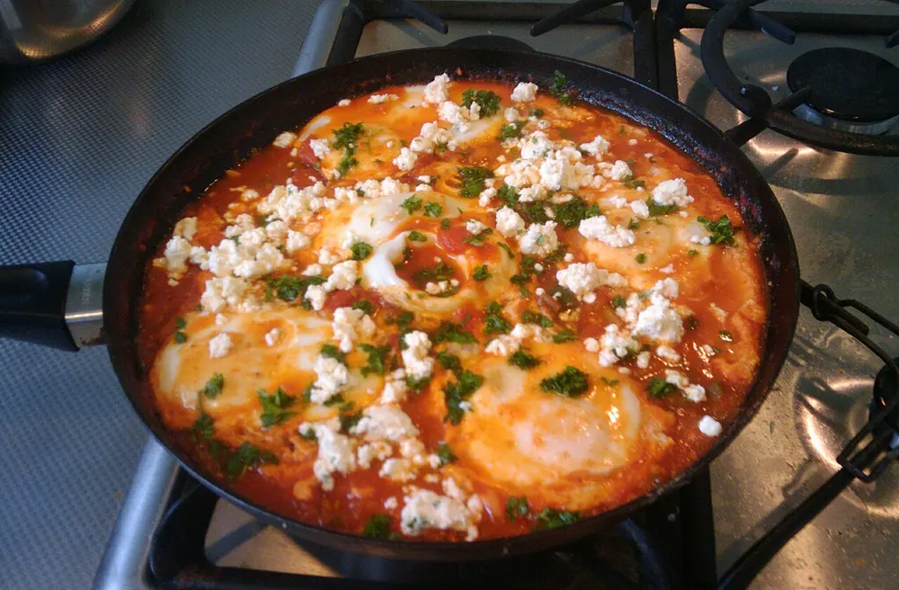 Shakshouka — eggs poached in a pan of tomato and pepper sauce