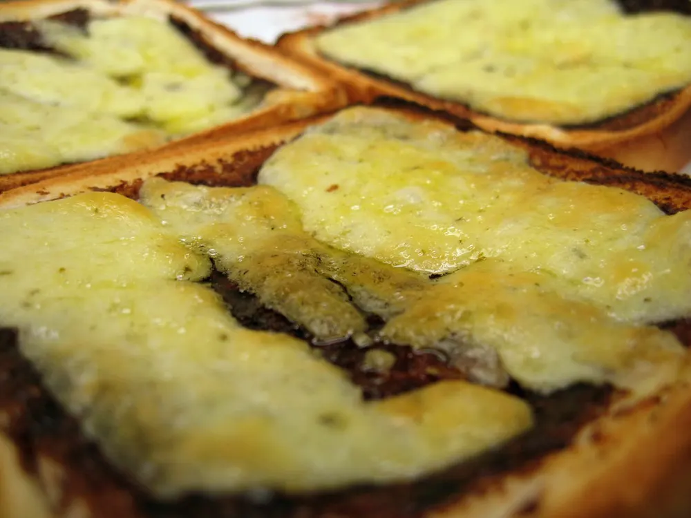 Vegemite on toast — buttered toast spread with savoury Vegemite, here with cheese