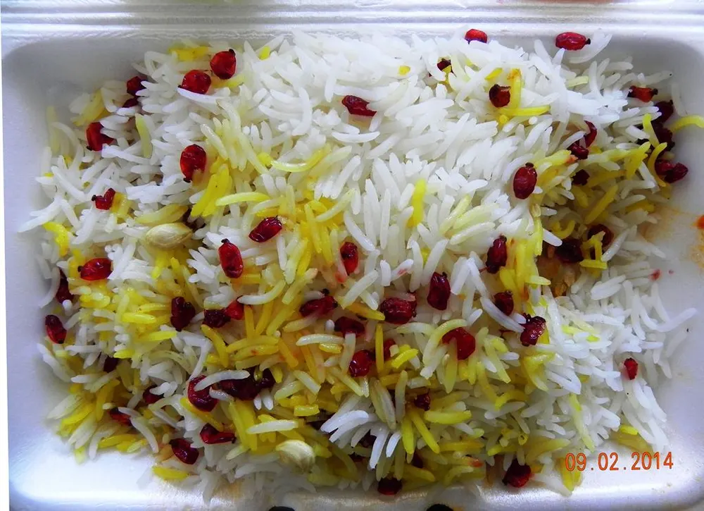 Zereshk polo — saffron rice studded with tart barberries, served with chicken